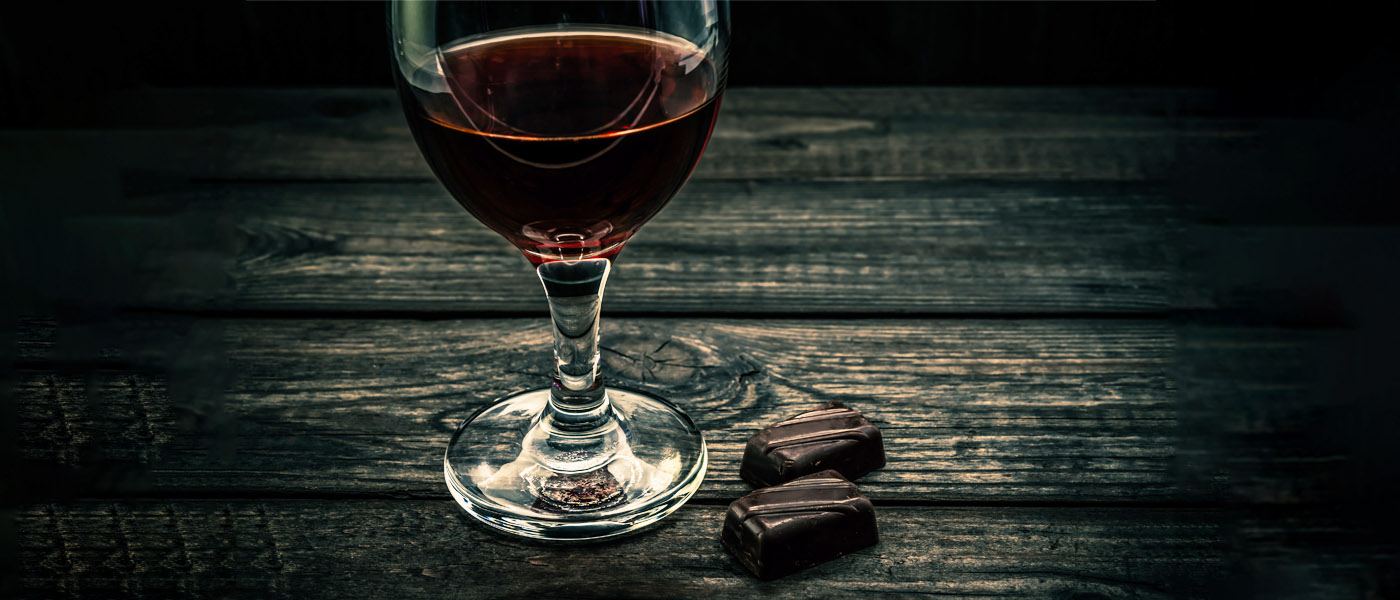 A glass of red wine and some dark chocolate