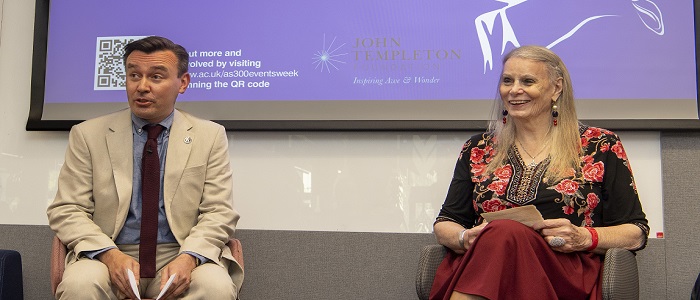 Deirdre McCloskey and Craig Smith Sitting with a presentation slide behind them with a QR code to the Adam Smith website and the John Templeton logo Source: University of Glasgow