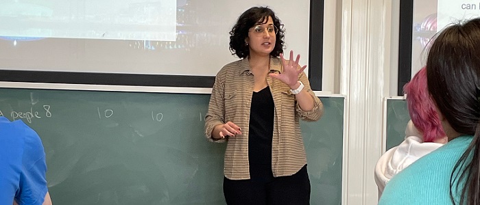 Ana Paula Londe Silva speaking with a presentation behind her of Adam Smith Source: Charlotte Morris