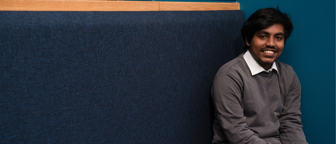 A student sitting on a workbench