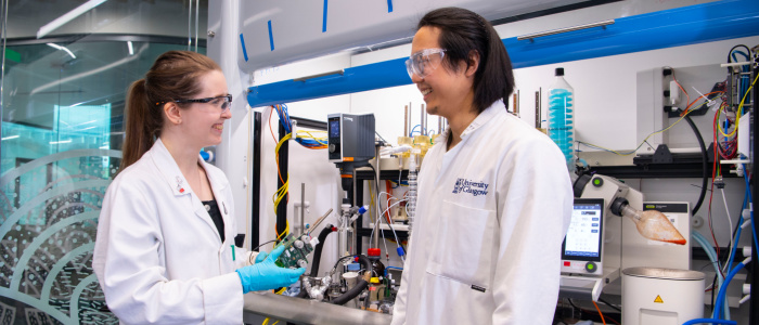 Researchers from Digital Chemistry wear lab coats while working in a lab