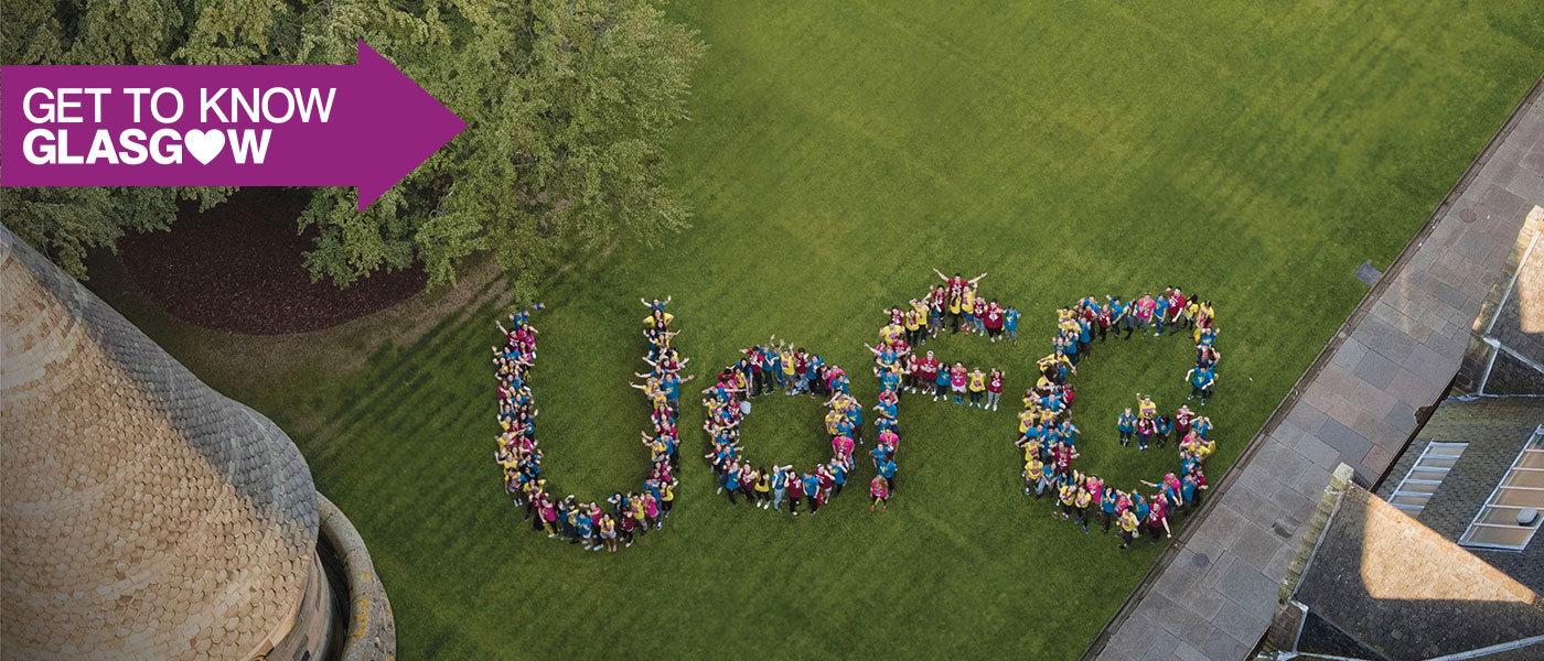 Students standing in the University's Quad spelling out U of G