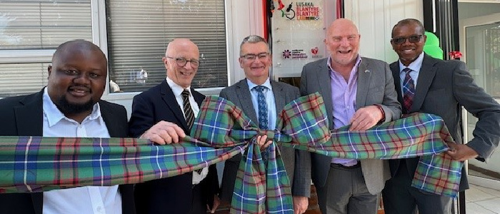 Left to right: Gordon Gandiya (Avacare Health), Prof Andy Waters, Prof Paul Garside, Robert Hanna (African Sun Energy), Dr Mwapatsa Mipando, University of Glasgow, Dean for Global Engagement, Africa (Acting) - all standing holding a tartan bow