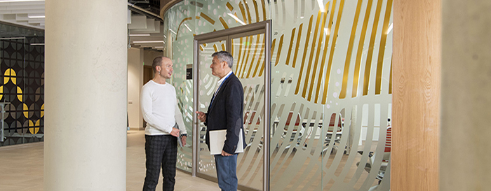 Two staff members talking at the university