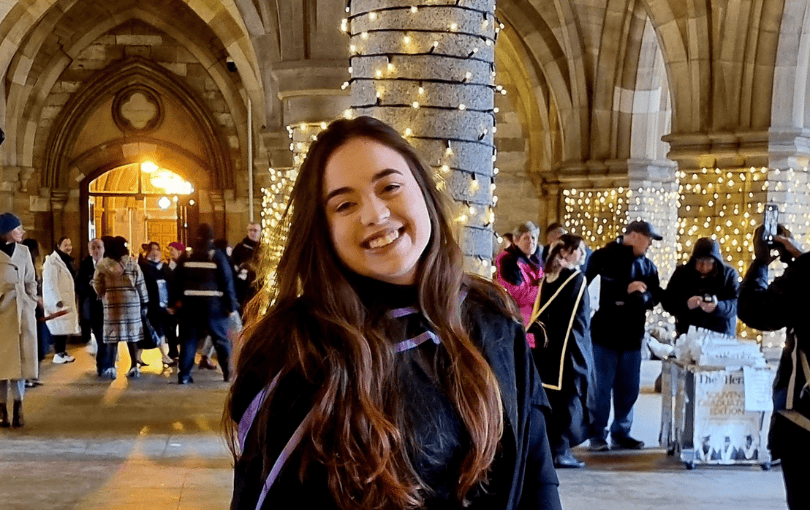 student in cloisters during graduation