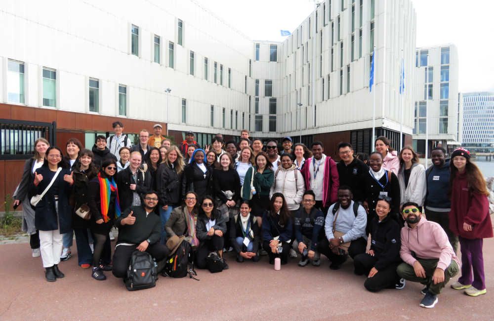A group photo of students outside of a modern building in Copenhagen