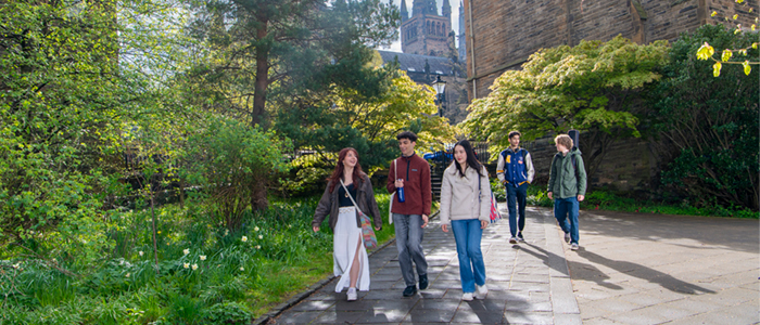 Group of students walking through main campus