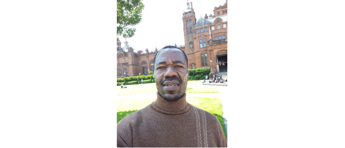 Junious Sichali, smiling at camera