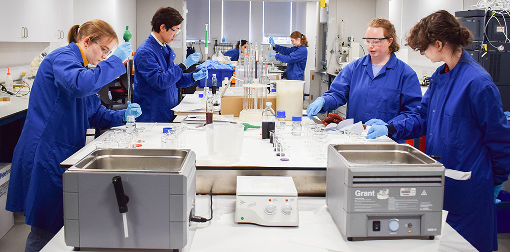 A group of students in a lab preparing dyes.