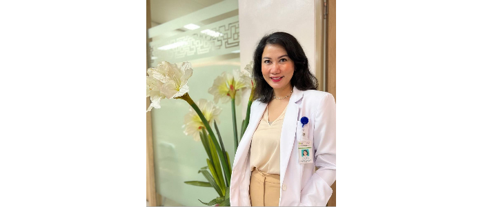 Kristiana Siste, smiling at camera