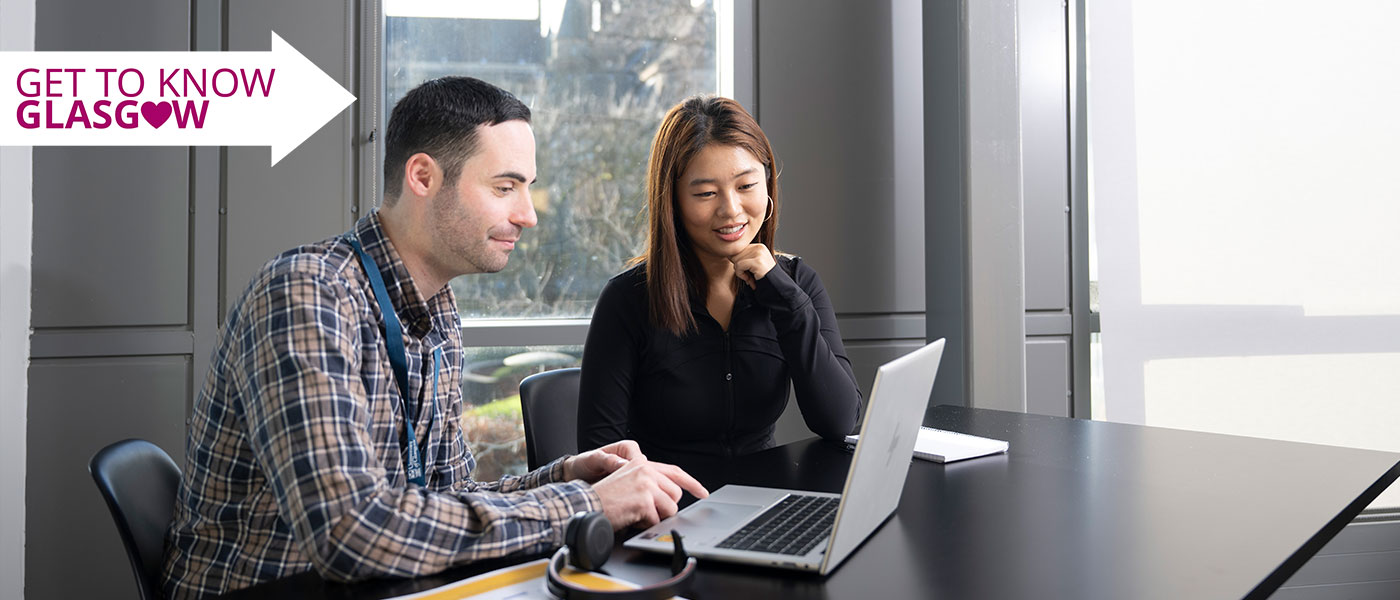 A staff member assisting a student in the Fraser Building