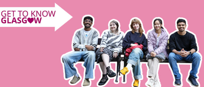 Five students smiling and sitting on benches