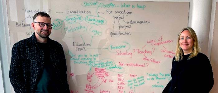 Researchers in front of a whiteboard