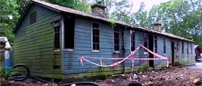 A image of Bobbin Mill hut with tape outside the building