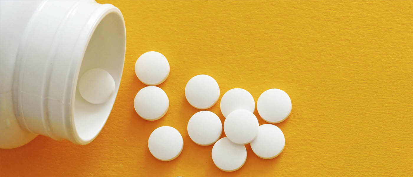 A pill bottle with tablets spilling out