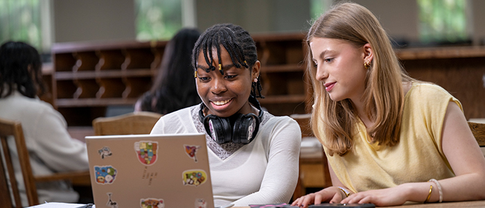 Two students sitting studying in the round reading room
