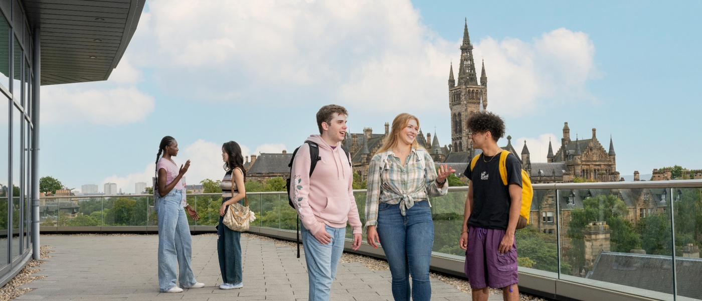 Group of students on JMS balcomy with tower in the background