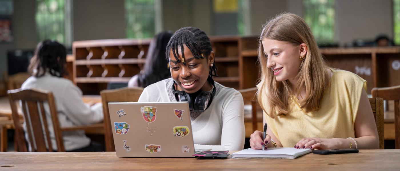 two students on a laptop in the reading room