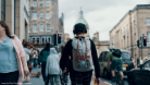 Person walking with backpack on in city