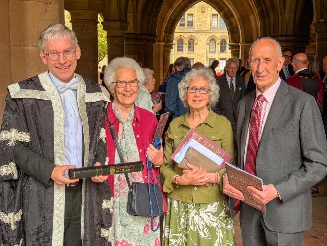 A photo of the Thompson family with Principal and Vice-Chancellor Andy Schofield in the University of Glasgow Cloisters