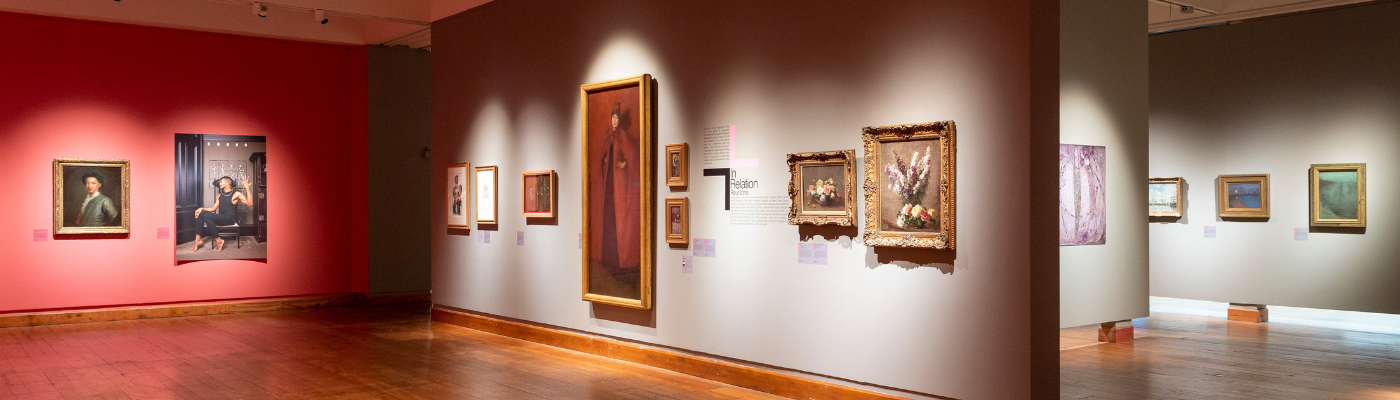 A picture of the inside of the Hunterian Art Gallery featuring multiple paintings