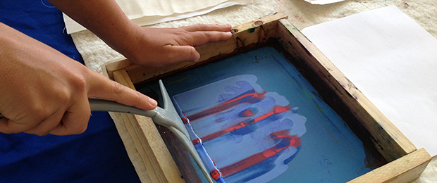 hand doing screen printing