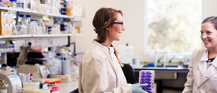 Image of two female students working in a lab