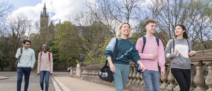 5 students in kelvingrove park with the Uni tower in the background
