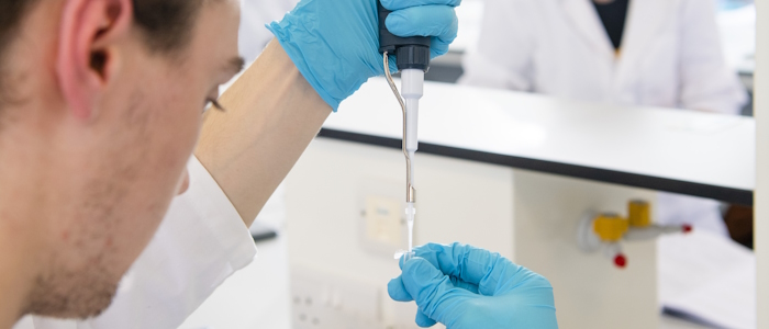 a lab worker with sample