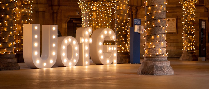 UofG letters lit up in undercroft during graduation
