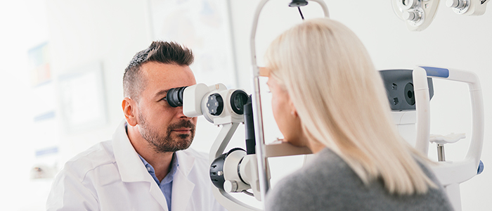 Patient being given an eye test by an optician