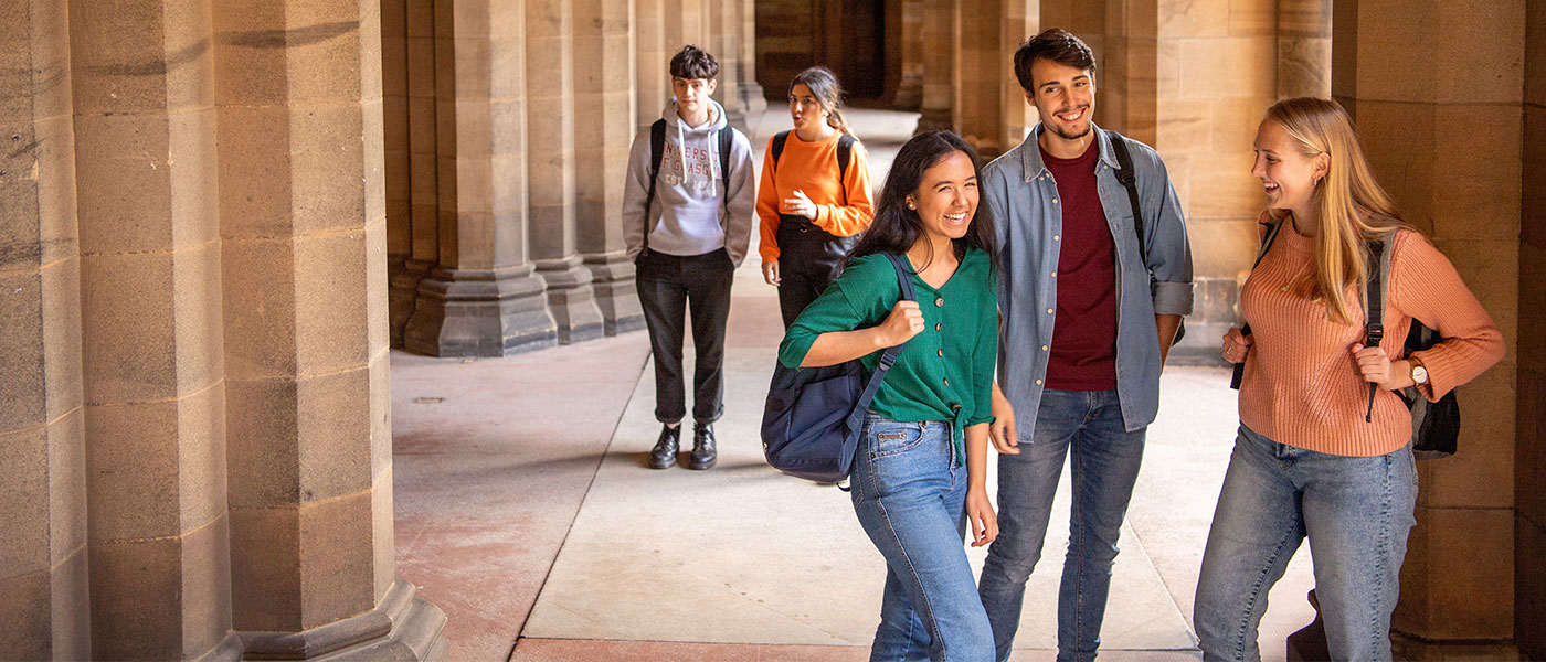 Students standing chatting in the cloisters