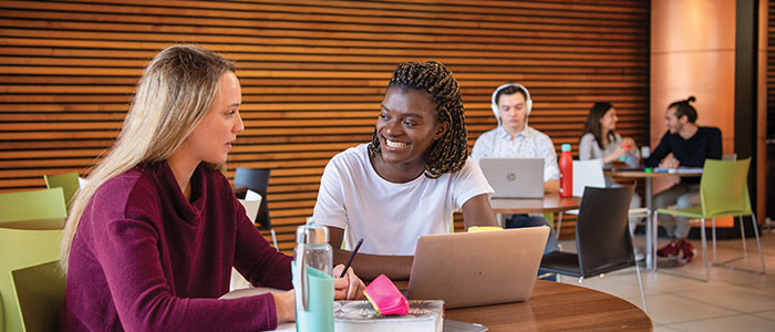 Students chatting in the library