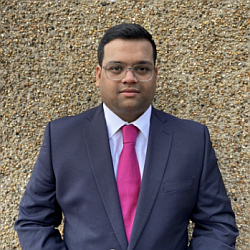 A portrait photo of Dennis Abraham