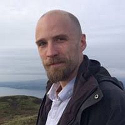 A portrait photo of Dr Andrew Reid