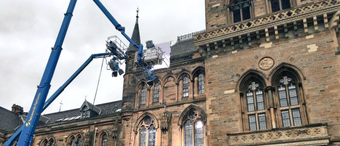 Filming gear on a cherry picker at the side of the Gilbert Scott building
