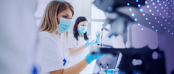 Two scientists in a lab with test tubes