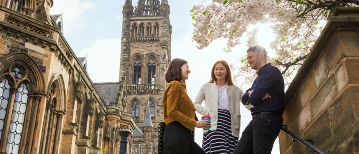 3 students beneath our ancient university tower