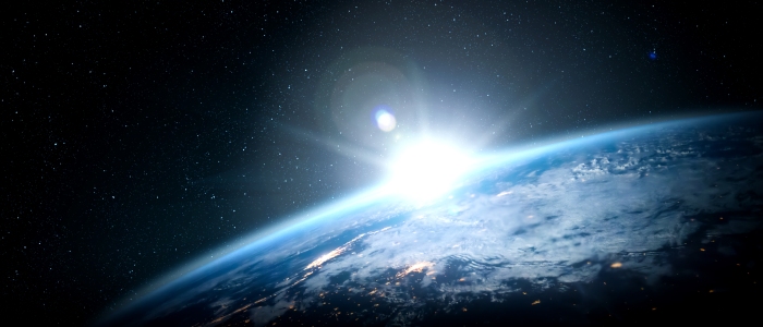 Sun rising over the Earth from space