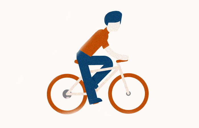 A cyclist wearing a turban with red wheeled bike