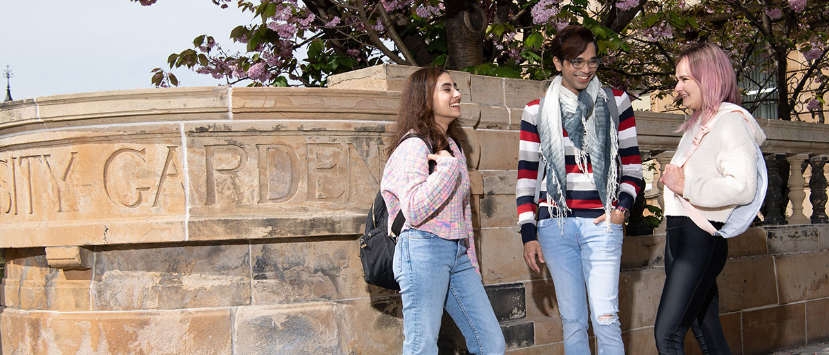 A group of three students chatting