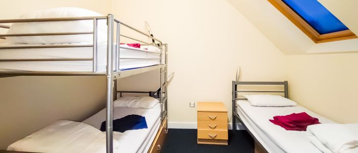 Slack building accommodation room showing bunk beds and one single bed