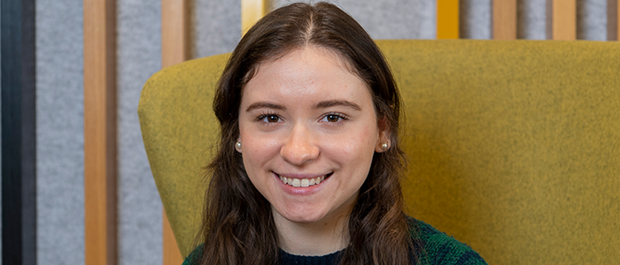 Image of Adriana sitting on a chair